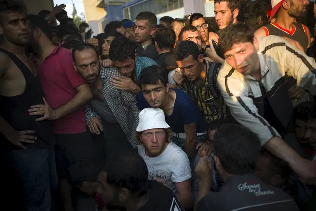 Migrants crowd around as they line up for a registration procedure at the port of Mytilene on the Greek island of Lesbos, September 3, 2015. (Photo by Dimitris Michalakis/Reuters)