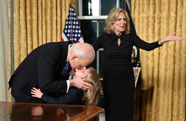 US President Joe Biden kisses his grand-son Beau Biden Jr. as First Lady Jill Biden gestures after the President delivered his farewell address to the nation from the Oval Office of the White House in Washington, DC, on January 15, 2025. (Photo by Mandel Ngan/Pool via Reuters)