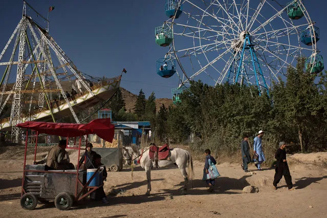 A horse stands in front of amusement park rides at Qargha Lake, a popular weekend destination on the outskirts of Kabul, on July 21, 2017 in Kabul, Afghanistan. Despite a heavy security presence throughout the city, life remains under constant threat of terror and unrest for residents. According to the United Nations, Kabul province had the highest number of civilian casualties in 2017 due to suicide and complex attacks in Kabul city. (Photo by Andrew Renneisen/Getty Images)