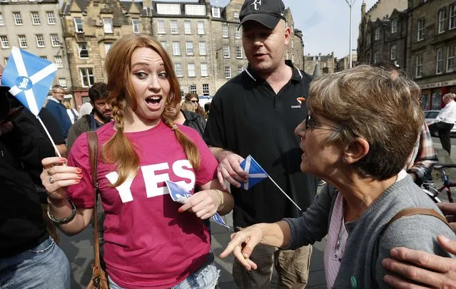 Opposing supporters for the Yes (L) and No campaigns, argue in Edinburgh, Scotland September 8, 2014. The British pound slid and the stock market shuddered on Monday after an opinion poll showed that Scots may vote for independence next week in a referendum that could herald the break up of the United Kingdom. The referendum on Scottish independence will take place on September 18, when Scotland will vote whether or not to end the 307-year-old union with the rest of the United Kingdom. (Photo by Russell Cheyne/Reuters)