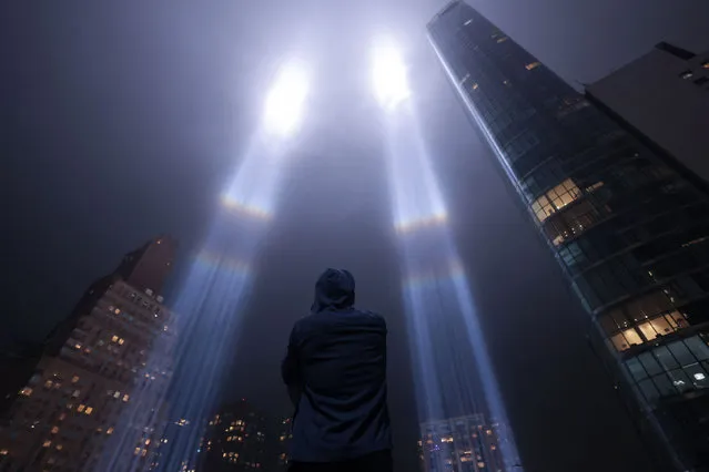 A person looks toward the Tribute in Light for the remembrance of the 21st anniversary of the September 11, 2001 attacks in Manhattan, New York City, U.S., September 11, 2022. (Photo by Andrew Kelly/Reuters)