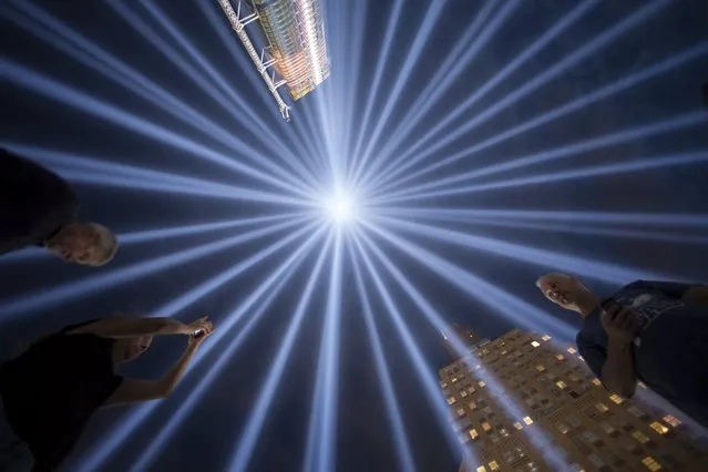 People gather at the “Tribute in Light” in Lower Manhattan, New York, September 9, 2015. The tribute was lit two days ahead of the 14th anniversary of the 9/11 terrorist attacks. (Photo by Andrew Kelly/Reuters)