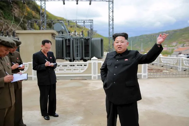 North Korean leader Kim Jong Un (R) gives field guidance during a visit to the construction site of the Paektusan Hero Youth Power Station near completion in this undated photo released by North Korea's Korean Central News Agency (KCNA) in Pyongyang September 14, 2015. (Photo by Reuters/KCNA)