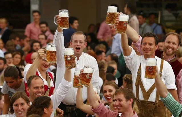 Visitors cheer with beer during the opening ceremony for the 182nd Oktoberfest in Munich, Germany, September 19, 2015. (Photo by Michael Dalder/Reuters)