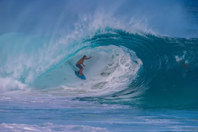 Hawaiian surfer Tamayo Perry goes into the tube at “Insanities” in Haleiwa on the North shore of Oahu as the first “big day” of Winter delivered the first big waves of the season in Hawaii on November 29, 2017. (Photo by Brian Bielmann/AFP Photo)