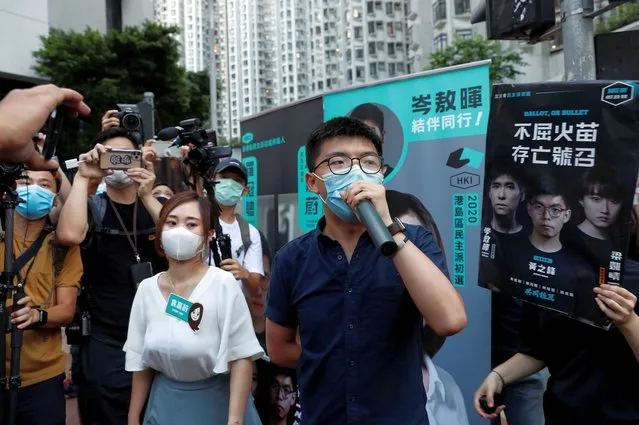 Pro-democracy activists Tiffany Yuen Ka-wai and Joshua Wong attend a campaigning during primary elections aimed for selecting democracy candidates, in Hong Kong, China on July 11, 2020. (Photo by Tyrone Siu/Reuters)