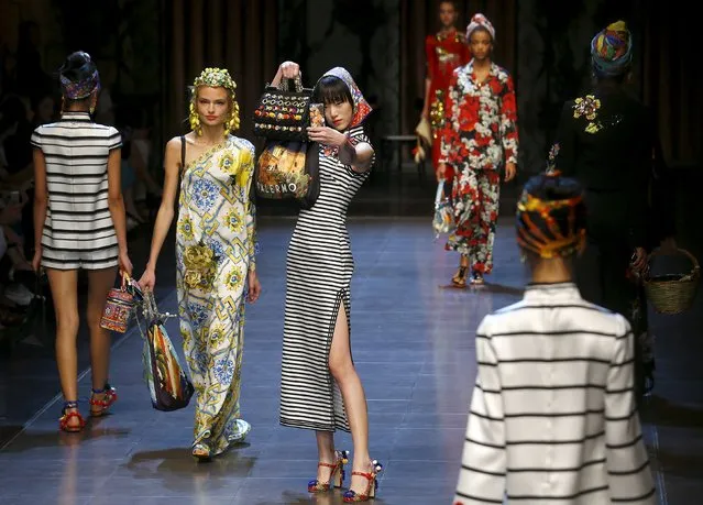 A model takes selfie with mobile phone as she presents a creation from the Dolce & Gabbana Spring/Summer 2016 collection during Milan Fashion Week in Italy, September 27, 2015. (Photo by Stefano Rellandini/Reuters)