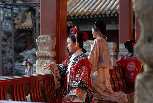People dressed in the traditional hanfu pose for photos in Beijing, China, 05 April 2025. (Photo by Jessica Lee/EPA/EFE)