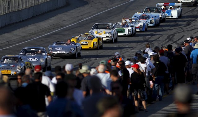 Race cars line up to parade around the track during the Porsche Rennsport Reunion V at Laguna Seca Raceway near Salinas, California, September 26, 2015. (Photo by Michael Fiala/Reuters)
