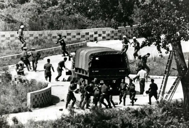 In this August 18, 1976 photo, North Korean soldiers attack United Nations Command personnel wearing helmets at the truce village of Panmunjom, South Korea. Straddling the world's most heavily fortified border, the Korean truce village of Panmunjom is a potentially dangerous flashpoint where North Korean soldiers hacked to death two American soldiers at the height of the Cold War. (Photo by Yonhap via AP Photo)