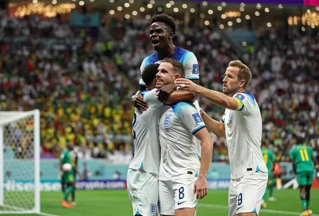 Jordan Henderson of England celebrates with team mates Bukayo Saka and Harry Kane after scoring his sides first goal during the FIFA World Cup Qatar 2022 Round of 16 match between England and Senegal at Al Bayt Stadium on December 04, 2022 in Al Khor, Qatar. (Photo by Marko Djurica/Reuters)