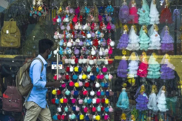 A man walks past a toys shop in Colombo on July 23, 2020. (Photo by Ishara S. Kodikara/AFP Photo)