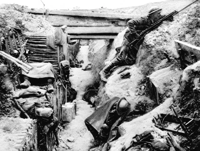 A British Grenadier Guardsman keeps watch on “No-Man's land” as his comrades sleep in a captured German trench at Ovillers, near Albert, during the Battle of the Somme in 1916. (Photo by EMPICS Sports Photo Agency)