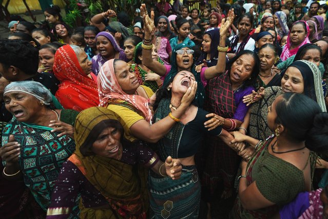 Family members and relatives of Akash Patni, victim of the Air India plane crash, grieve during his funeral procession in Ahmedabad, India, Tuesday, June 17, 2025. (Photo by Ajit Solanki/AP Photo)