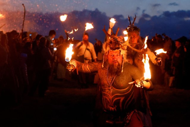 Performers hold fire during a procession at the Bealtaine fire festival, marking the beginning of summer at the Hill of Uisneach in Rathnew, Ireland, on May 10, 2025. (Photo by Clodagh Kilcoyne/Reuters)
