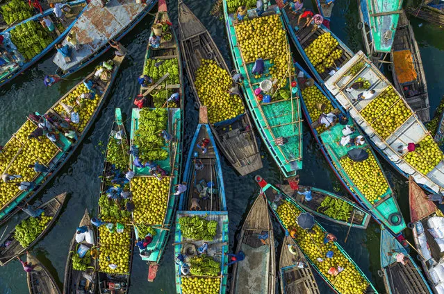 Tribal people from the Kaptai Lake area in Bangladesh in November 2022 bring a colourful array of cultivated fruit to market in Rangamati, including grapefruit, banana, hog plum, pineapple, green coconut and papaya. (Photo by Asker Ibne Firoz/Solent News)