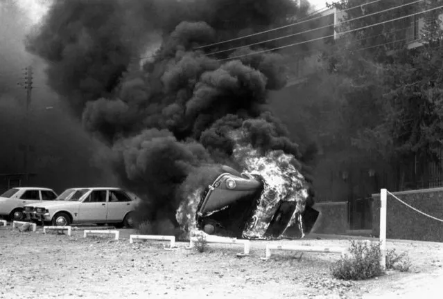 Smoke billows from cars in front of the United States embassy in Nicosia, on August 19, 1974 as Angry Greek Cypriots stormed the building. The Greek Cypriots were protesting against American policy over Cyprus. United States ambassador to Cyprus, Rodger P. Davies, was killed during the incident. (Photo by AP Photo)