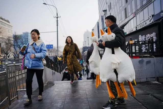 A man wearing a face mask sells toy ducks on the street in Beijing, China, 10 February 2023. According to the report on 10 February by the National Bureau of Statistics, China's Consumer Price Index (CPI), which is a main gauge of inflation, rose to 2.1 percent in January 2023 from 1.8 percent in previous month, compared with market forecasts of 2.2 percent. This was the highest reading in three months, as prices of food rised and those of non-food gained further following the Lunar New Year and the lift of COVID-19 measures. (Photo by Wu Hao/EPA/EFE)
