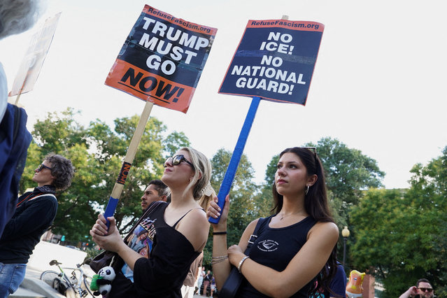 Women display signs as people protest at Dupont Circle in Washington, on August 11, 2025. (Photo by Ken Cedeno/Reuters)