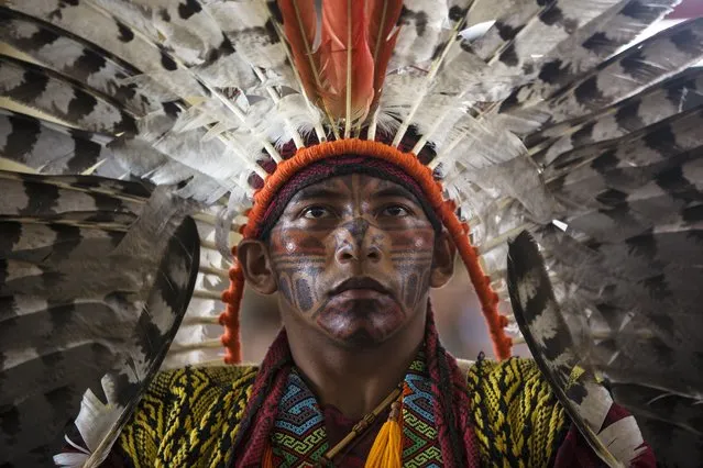 Antonio Borges Serum, of the ethnic group “Hunikui” from Acre, Brazil, listens to a speech during a meeting by Amazonian indigenous in Puerto Maldonado, Madre de Dios province, Peru, Thursday, Jan. 18, 2018, one day ahead of Pope Francis' arrival to Peru's Amazon. (Photo by Rodrigo Abd/AP Photo)