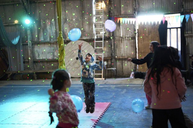 Children play before a circus performance during their mid-year winter break, in Buenos Aires, Argentina, August 2, 2025. (Phoot by Rodrigo Abd/AP Photo)