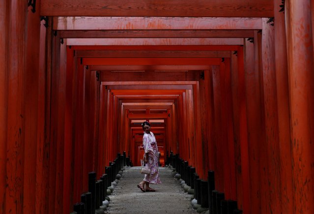 A visitor poses for a photo at Fushimi Inari Shrine in Kyoto, Japan, on July 18, 2025. (Photo by Kim Kyung-Hoon/Reuters)