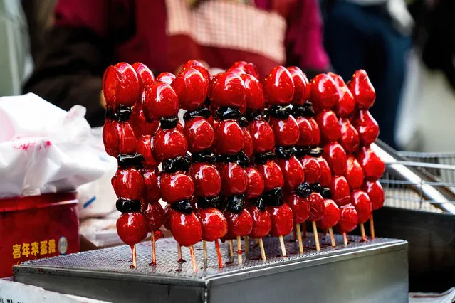 Sugar coated strawberries on a stick are seen for sale at an outdoor market in Taichung, Taiwan on March 5, 2023. In a bid to draw more international tourists, the Taiwanese Government recently announced that it would be giving 5000 Taiwan Dollars (approx. 165 USD) as a part of a stimulus package to help subsidise travel for tourists. (Photo by Matt Hunt/SOPA Images/Rex Features/Shutterstock)