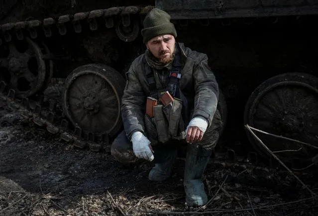 A wounded Ukrainian service member is seen near a military vehicle, as Russia's attack on Ukraine continues, in the front line city of Bakhmut, Ukraine on March 3, 2023. (Photo by Oleksandr Ratushniak/Reuters)
