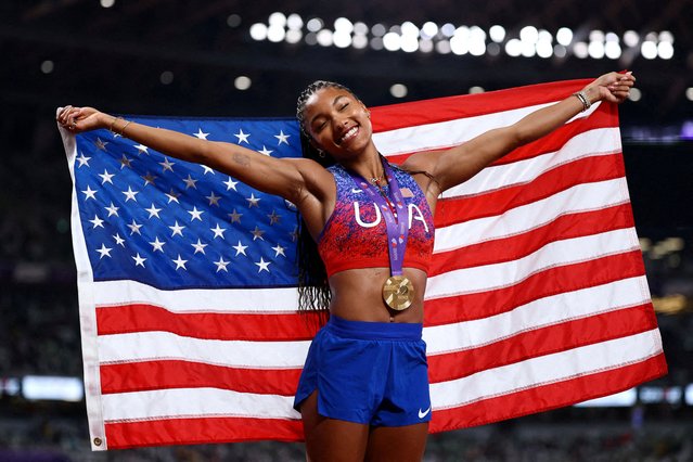 Tara Davis-Woodhall of the U.S. celebrates with a gold medal and U.S. flag after winning the Women's Long Jump Final on September 14, 2025. (Photo by Sarah Meyssonnier/Reuters)
