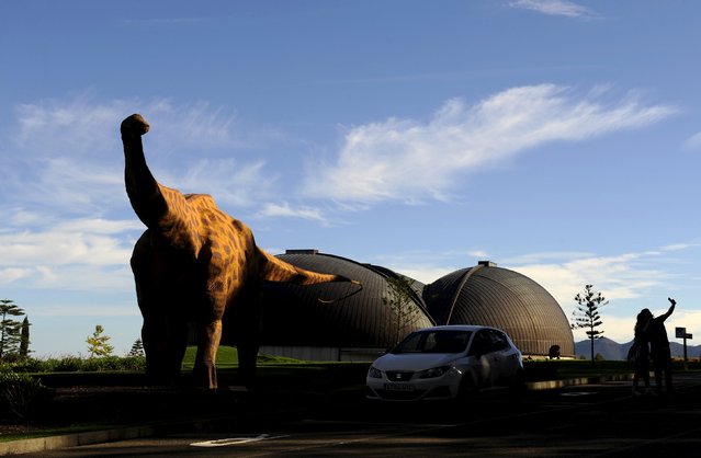 A couple takes a photo outside the MUJA (Jurassic Museum of Asturias) in Colunga, northern Spain, November 6, 2015. (Photo by Eloy Alonso/Reuters)