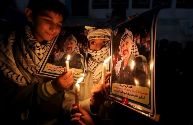 Palestinian boys light candles during a protest marking the 11th anniversary of Palestinian leader Yasser Arafat's death, in Khan Younis in the southern Gaza Strip November 11, 2015. Arafat died on November 11, 2004. (Photo by Ibraheem Abu Mustafa/Reuters)