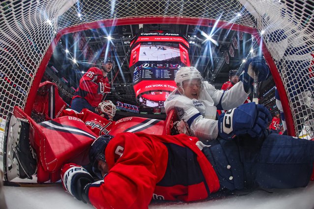 Jakob Chychrun #6, goalie Logan Thompson #48 of the Washington Capitals, and Pontus Holmberg #29 of the Tampa Bay Lightning collide in the goal during the third period at Capital One Arena on October 14, 2025 in Washington, DC. (Photo by Patrick Smith/Getty Images)