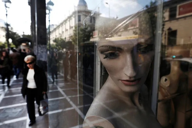A woman walks past mannequins in a closed shop at central Athens November 15, 2012. (Photo by John Kolesidis/Reuters)