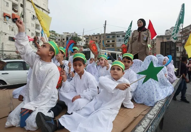 Members of Muslim Scout Association hold decorations during a rally to welcome the holy fasting month of Ramadan, in Sidon, Lebanon on March 22, 2023. (Photo by Aziz Taher/Reuters)