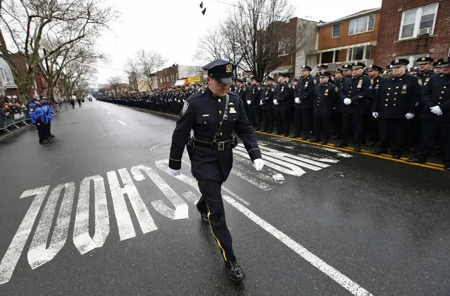 New York City police line the streets for the funeral service of New York Police Department officer Wenjian Liu in the Brooklyn borough of New York January 4, 2015. (Photo by Mike Segar/Reuters)