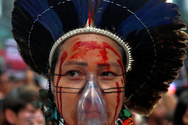 An activist from Pataxo tribe attends a protest against the climate crisis in the country, in Sao Paulo, Brazil on September 22, 2024. (Photo by Felipe Iruata/Reuters)