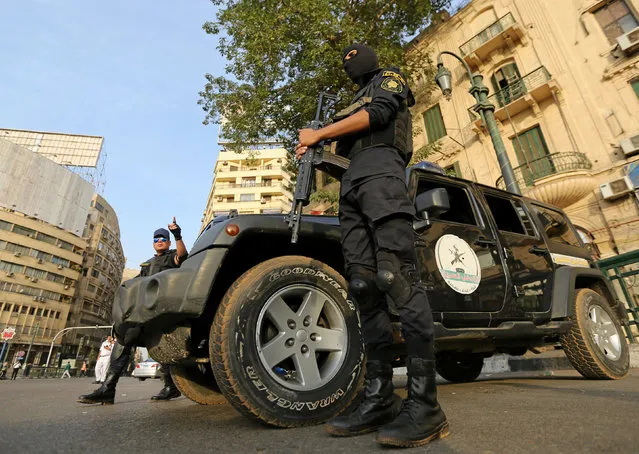 Members of security forces secure Tahrir Square in Cairo, Egypt, November 11, 2016. Egypt imposed a big security clampdown in its cities on Friday as mass demonstrations called to protest against austerity measures failed to take place. Riot police and armored vehicles filled the otherwise empty streets of central Cairo, but most people stayed at home. President Abdel Fattah al-Sisi has urged Egyptians not to protest and warned that there would be no going back on economic reforms, no matter how much pain they might cause. In a boost for the government, the International Monetary Fund's executive board approved a three-year, $12 billion loan to Egypt aimed at supporting the reforms, and the central bank said it received a first tranche of $2.75 billion. A little-known group calling itself Movement of the Poor had called for Egyptians to protest on Nov. 11 against deepening austerity measures the government says are required to save the Arab world's most populous nation from financial ruin. But big protests failed to materialize across the country by 8:30 p.m (18:30 GMT). Police dispersed several small gatherings and there were some minor clashes. No one was killed or injured. “The Egyptian people chose stability and development and rejected any calls against that”, state television quoted Prime Minister Sherif Ismail as saying. The calls to protest began in August, but gained traction on social media last week after Egypt raised fuel prices and floated its currency – a move welcomed by bankers but condemned by ordinary people as the latest blow to their diminishing spending power. (Photo by Mohamed Abd El Ghany/Reuters)