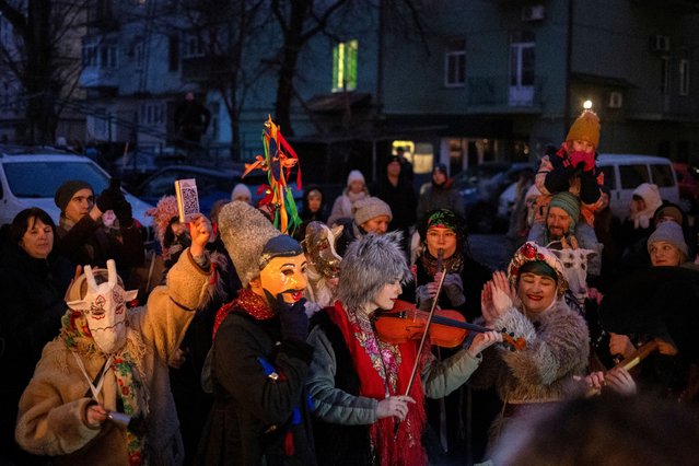 Revellers play folk music and wear traditional costumes designed to ward off evil spirits and bring good fortune for the next year, during a Malanka Ukrainian folk celebration, amid Russia's attack on Ukraine, in a courtyard in Kyiv, Ukraine, on December 29, 2024. (Photo by Thomas Peter/Reuters)