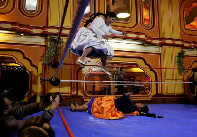 A Cholita (Andean woman) fighter jumps over their opponent at the Havana Hotel Cholet in El Alto, outskirts in La Paz, Bolivia on June 29, 2018. (Photo by David Mercado/Reuters)