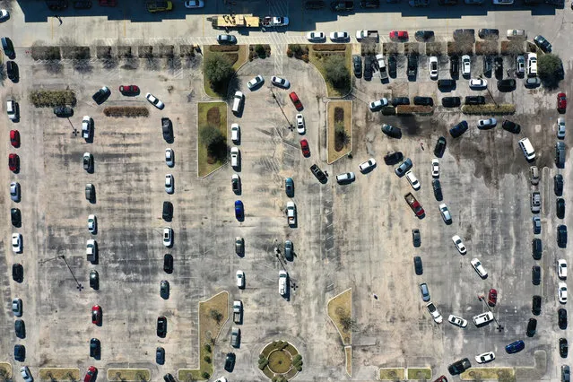 An aerial drone view of cars lining up for a water distribution event at the Fountain Life Center on February 20, 2021 in Houston, Texas. Much of Texas is still struggling with historic cold weather, power outages and a shortage of potable water after winter storm Uri swept across 26 states with a mix of freezing temperatures and precipitation. Many Houston residents do not have drinkable water at their homes and are relying on city water giveaways. (Photo by Justin Sullivan/Getty Images)