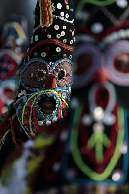 Masked Bulgarian dancers take part in the second competition day of the 24th International Festival of Masquerade Games “Surva” in the town of Pernik, Bulgaria Saturday, January 31, 2015. (Photo by Valentina Petrova/AP Photo)