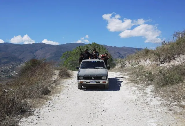 Members of the Community Police of the FUSDEG (United Front for the Security and Development of the State of Guerrero) patrol in a truck in the village of Petaquillas, on the outskirts of Chilpancingo, in the Mexican state of Guerrero, February 1, 2015. (Photo by Jorge Dan Lopez/Reuters)
