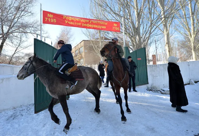 Kyrgyz men arrive on their horses to a polling station during a referendum on the constitution in Bishkek on December 11, 2016. Citizens in ex-Soviet Kyrgyzstan went to the polls to vote on a raft of amendments to the constitution promoted by the country's leader, several of which have been slammed by rights groups. (Photo by Vyacheslav Oseledko/AFP Photo)