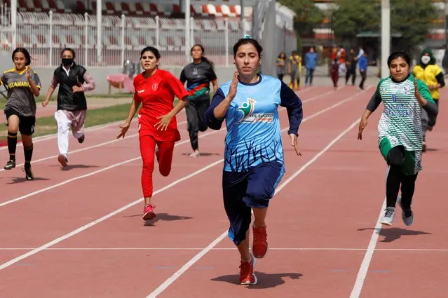 Women participants take part in a race during a sports event in connection with International Women's Day celebrations in Peshawar, Pakistan on March 8, 2021. (Photo by Fayaz Aziz/Reuters)
