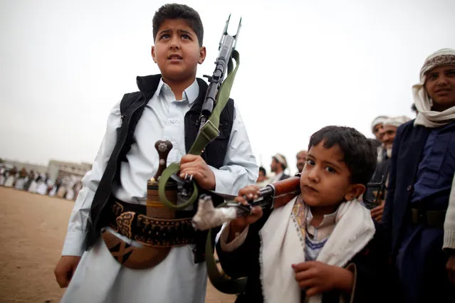 Boys carry weapons during a tribal gathering held to show support to the Houthi movement in Sanaa, Yemen November 10, 2016. (Photo by Khaled Abdullah/Reuters)