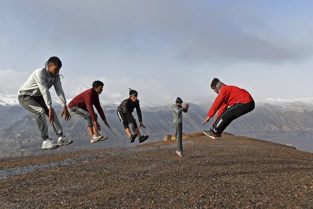 Athletes train in Muay Thai form of martial arts atop the hills of Salsal Buddha, the site of the Buddhas of Bamiyan statues, which were destroyed by the Taliban in 2001, in Bamiyan province on March 14, 2021. (Photo by Wakil Kohsar/AFP Photo)