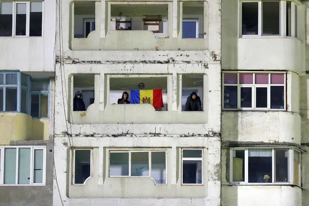 Supporters of Moldova national soccer team watch the match from their apartment building during the 2022 World Cup Qualifying round soccer match Moldova vs Faroe Islands at Zimbru stadium in Chisinau, Moldova, 25 March 2021. (Photo by Dumitru Doru/EPA/EFE)