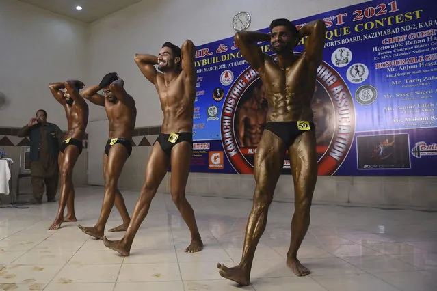Bodybuilders flex their muscles during a bodybuilding competition in Karachi on March 14, 2021. (Photo by Rizwan Tabassum/AFP Photo)