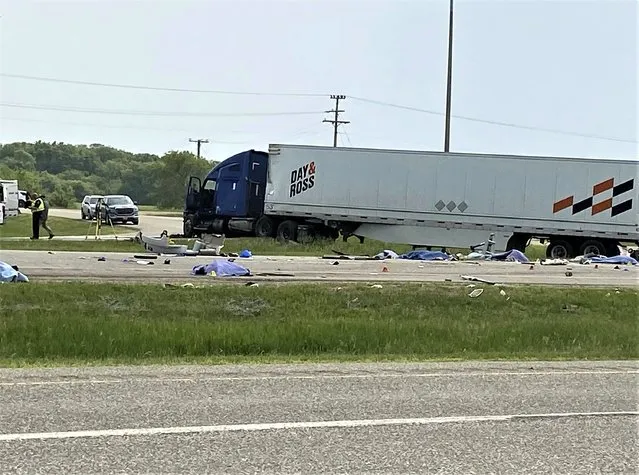 This photo shows the scene of a major collision that has closed a section of the Trans-Canada Highway near Carberry, Manitoba  on Thursday June 15, 2023. Authorities did not confirm casualties, but health officials said they were preparing a mass casualty response. (Photo by Steve Lambert/The Canadian Press via AP Photo)