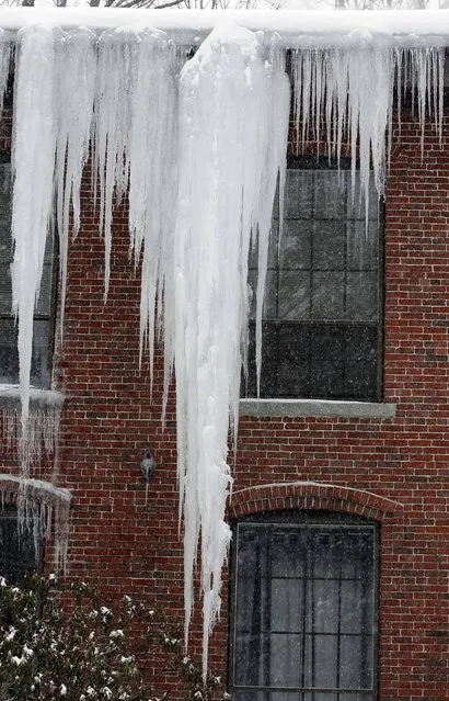 A large icicle hangs  from an apartment building Monday, February 9, 2015, after several snowstorms in Concord, N.H.  (Photo by Jim Cole/AP Photo)